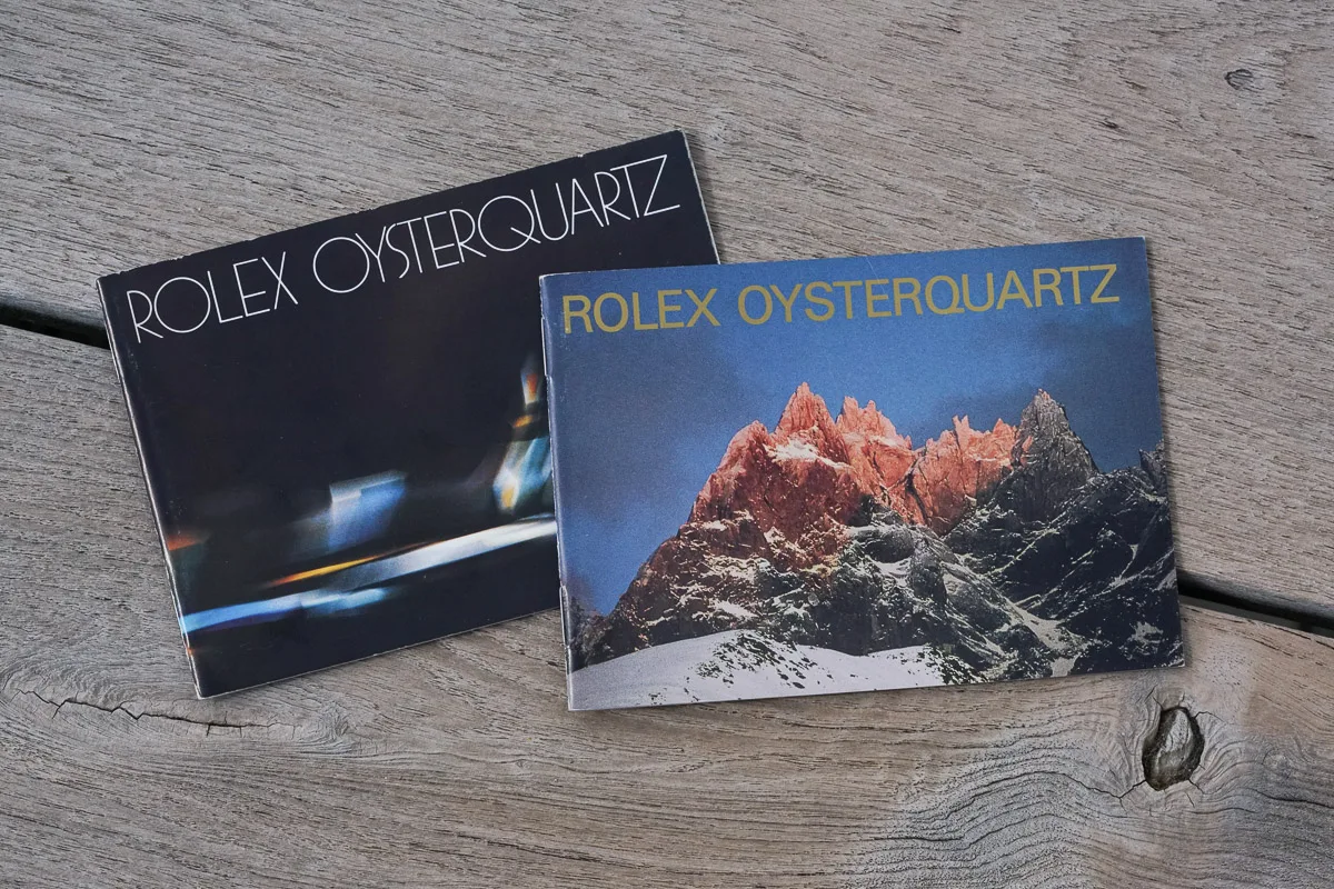 Two Rolex Oysterquartz booklets on wood