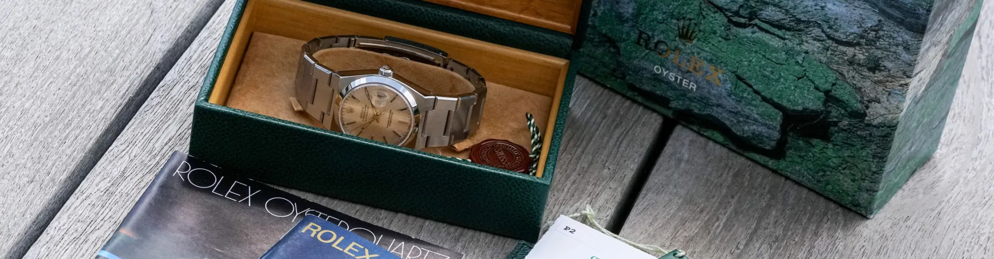 Rolex Oysterquartz in an open green Rolex box on a wooden surface